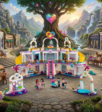A colorful fantasy-style illustration of a children's building block set arranged in a whimsical town square. The central product is a multi-story pink, purple, and white toy building set with a staircase, storefronts, and small character figures.