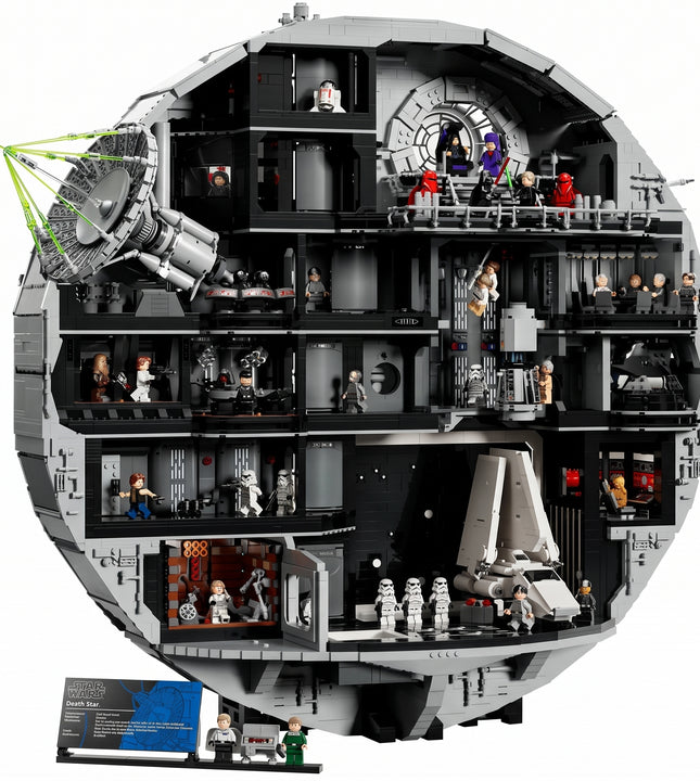 A detailed cross-section view of a large gray and black circular LEGO structure, showing multiple interior levels, minifigures, and small accessories on a plain white background.