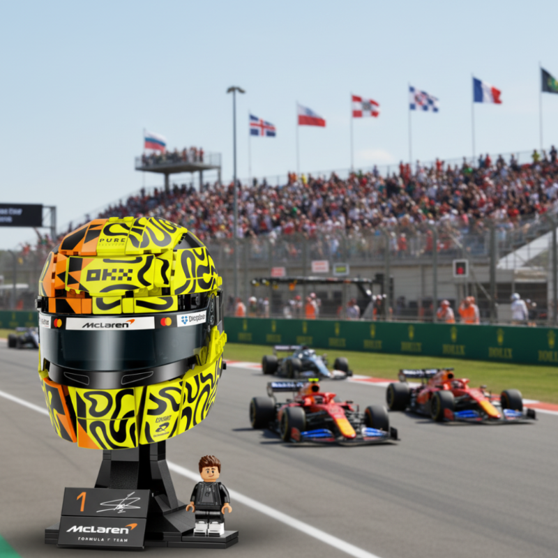 A building-block style racing helmet display on a black stand, featuring a neon yellow and black patterned helmet with orange accents, a dark visor, and visible McLaren and Dropbox branding. A small driver minifigure stands beside the stand on a branded plaque.