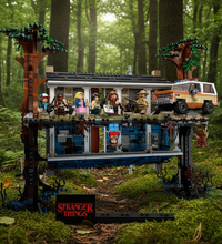 A Stranger Things themed treehouse set with multiple minifigures, a van, and a small black display plaque at the bottom. The set is photographed on a plain white background.