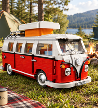 A red and white toy Volkswagen Type 2 campervan built from LEGO, shown from a three-quarter front angle on a solid white background.