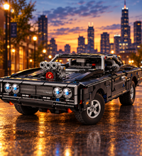 A black LEGO model of a muscle car with an exposed engine bay, featuring a detailed V8 engine, dual front headlights, and a roll cage, shown on a white background.