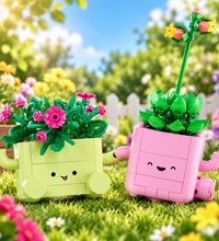 Two cute block-built flower pots with smiling faces, one pale yellow and one pink, each holding green leaves and flowers, shown on a plain white background.