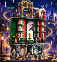 A highly detailed LEGO building set of a multi-story tower or station building, featuring green, red, gray, and beige brickwork with minifigures, a red telephone booth, and small character figures, shown on a plain white background.