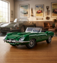 A green brick-built convertible sports car, resembling a classic Jaguar E-Type, shown from a three-quarters front angle on a white background.