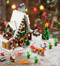 A LEGO Christmas village set featuring a snow-covered gingerbread house, a decorated Christmas tree, a sleigh with a reindeer, and several elf minifigures, shown on a plain white background.