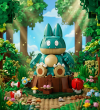 A building-block toy set featuring a large teal and tan character figure seated on a brown base with green foliage, small flowers, mushrooms, and red-and-white accessory pieces on a plain white background.