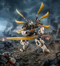 A assembled toy mecha robot stands in a ruined war scene, holding a large yellow sword. The robot is primarily white and gray with strong yellow accents, set against a dark smoky battlefield background.